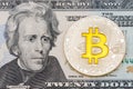 Golden cruptocurrency yellow `bitcoin on twenty dollar banknote Royalty Free Stock Photo