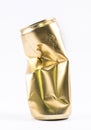 Golden crushed, deformed can on a white background Royalty Free Stock Photo
