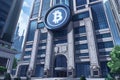 golden crypto currency coin with bitcoin symbol on the building