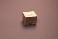 golden cube isolated on brown surface