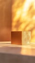 Golden cube on a sunlit surface, abstract art concept Royalty Free Stock Photo