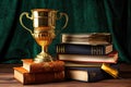 golden cup placed on a stack of books, symbolizing academic success Royalty Free Stock Photo
