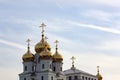 Golden cupolas against a pale bluish sky.