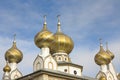 Golden cupolas with silvery crucifixes on onion domes of church Royalty Free Stock Photo