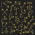 Golden curvy and odd shape hand drawn direction arrows and pointers set on black