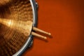 Golden Cymbal on a Snare Drum with two Wooden Drumsticks - Percussion Instrument