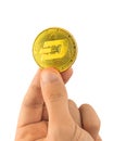 Golden Dash coin in hand isolated on white background, cryptocurrency symbol close-up photo Royalty Free Stock Photo