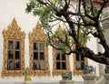 Golden decorated windows in a Buddhist temple in Bangkok
