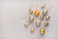 Golden decoration balls, ornaments on neutral beige linen background. Aesthetic minimalist New Year celebration backdrop