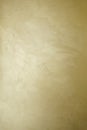 Golden decorative plaster texture with pearl glow