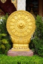 Golden Dharmachakra or Wheel of Dhamma symbol of Buddhism at temple in Thailand Royalty Free Stock Photo