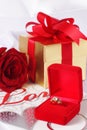 Golden diamond ring with gift box and red rose Royalty Free Stock Photo