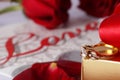 Golden diamond ring with gift box and red rose Royalty Free Stock Photo