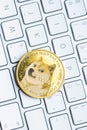 Golden dogecoin coin. Cryptocurrency dogecoin. Doge cryptocurrency and computer keyboard