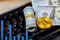 Golden dogecoin cryptocurrency coin lying on a pile of US dollar cash banknotes, Gold Bitcoin keyboard