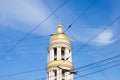 golden dome of bell tower of Cathedral of Vladimir Icon of Mother of God and wires on blue sky. view from below from street. St.