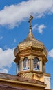 Golden dome of the church. Background of blue sky and white clouds. Royalty Free Stock Photo