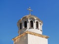 Golden dome with a cross on the Christian Orthodox Church shines on a sunny day against blue sky. Greek and Balkan church Royalty Free Stock Photo