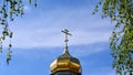 Golden dome of the Orthodox Church with a cross on a blue sky background Royalty Free Stock Photo