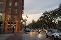 The golden dome of Savannah City Hall with cars driving on the street and people walking on the sidewalk Royalty Free Stock Photo