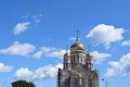 Golden domes of an Orthodox church with crosses on background of blue sky with white clouds. Reconstruction of church Royalty Free Stock Photo