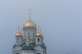 Golden domes of a Russian Orthodox Church in Barnaul, Russia, on a misty morning Royalty Free Stock Photo