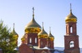 Golden domes of the temple against the blue clear sky. Christianity, religion Royalty Free Stock Photo