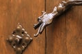 Golden door handle with mythological dragon shape on old wooden door