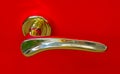 Golden door handle on red background Royalty Free Stock Photo