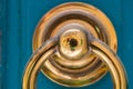 Golden door knocker on a blue wooden door Royalty Free Stock Photo