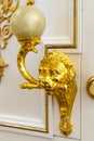 Golden door knocker in the shape of lion on a wooden door Royalty Free Stock Photo