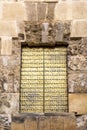 Golden door in the Mosque Cathedral in Cordoba, Spain. Exterior wall - famous landmark in Andalusia