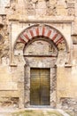 Golden door in the Mosque Cathedral in Cordoba, Spain. Exterior wall - famous landmark in Andalusia