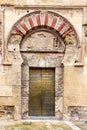 Golden door in the Mosque Cathedral in Cordoba, Spain. Exterior wall - famous landmark in Andalusia