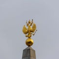 Golden double-headed eagle against the grey sky.