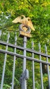 Golden double-headed eagle as a decorative element of a cast-iron fence post.