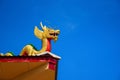 Golden dragon statue on the roof of the temple building. Royalty Free Stock Photo