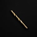 Golden drill bit isolated on black background