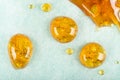 Golden drops of cannabis wax macro closeup