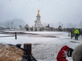 Golden eagle fountain statue round about front of buckingham palace street road fog winter snow grey London day police Royalty Free Stock Photo