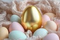 A golden Easter egg stands out in the center, surrounded by various pastel-colored eggs nestled in soft fabric Royalty Free Stock Photo