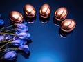 Golden Easter Eggs and Elegant Iris Flowers on a Dark blue background Royalty Free Stock Photo