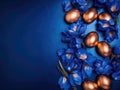 Golden Easter Eggs and Elegant Iris Flowers on a Dark blue background Royalty Free Stock Photo