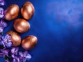 Golden Easter Eggs and Elegant Iris Flowers on a Dark blue background Royalty Free Stock Photo