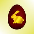 Golden Easter rabbit on a red Easter egg