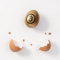 Golden egg with a bitcoin sign and eggshell on white background. Minimal investment concept Royalty Free Stock Photo