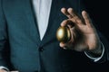 Golden egg in businessman hand. concept of success, profit, or wealth Royalty Free Stock Photo