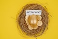 Golden egg and coins with retirement word on nest Royalty Free Stock Photo