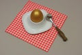 Golden egg in an egg cup on a red Royalty Free Stock Photo