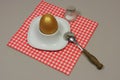 Golden egg in an egg cup Royalty Free Stock Photo